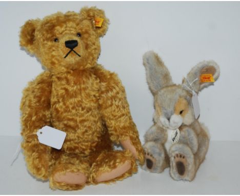 A modern Steiff Teddy bear, 30cm long and a modern Steiff Poppel, 15cm high (2) Condition report: Available upon request