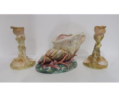 A Royal Worcester shell shaped centrepiece, painted in colours and a pair of Dolphin and shell shaped candlesticks Condition 