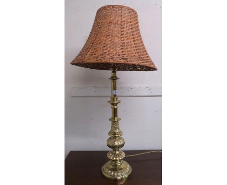 A 20th century cast brass table lamp with wicker lamp shade Condition report: Available upon request