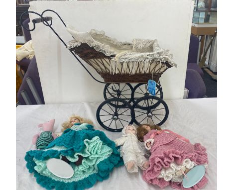 Vintage dolls pram with a selection of dolls and bears 