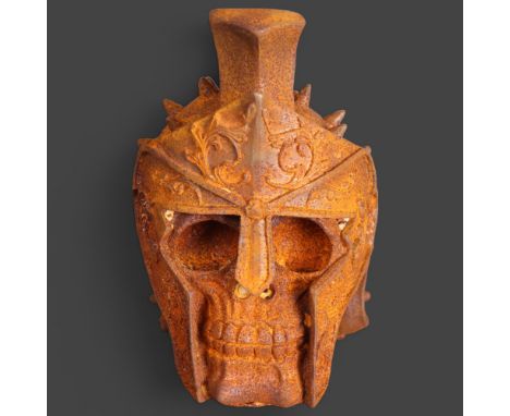 Curiosity/Macabre : A metallic sculpture of a skull, with armoured helmet, unsigned, height 16.5cm. 