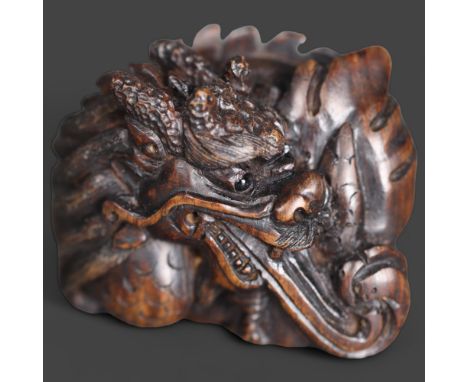 Netsuke: Japanese Dragon. Hand carved hardwood netsuke, with inlaid bone disc signature, of a Japanese Dragon, also known as 