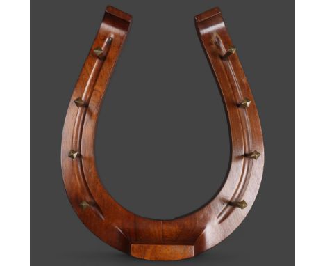 A mahogany horseshoe whip rack, overall length 47cm. 