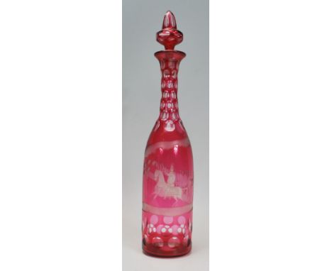 A late 19th / early 20th Century etched cranberry glass decanter, the decanter etched with a soldier on horse back leading hi