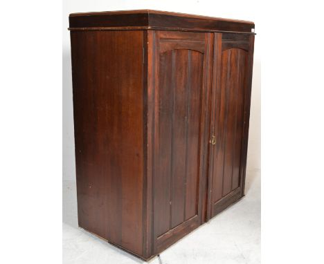 A vintage early 20th Century converted mahogany linen press top having paneled doors concealing a series of drawers within ra