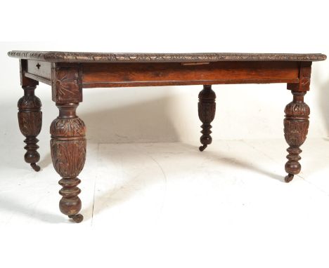 A large Victorian 19th century oak dining table. Raised on bulbous cup and cover legs with ceramic castors. Fitted frieze wit