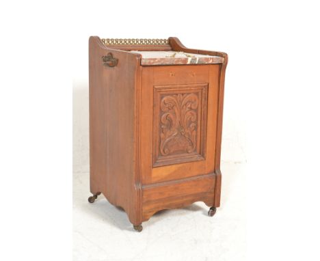 A Victorian 19th century oak and marble top fall front coal scuttle purdonium having a gallery back with marble top, carved f