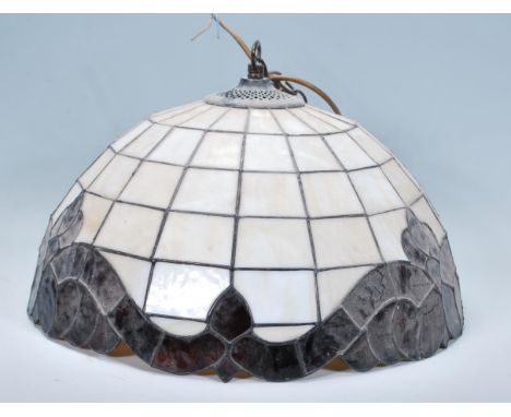 A contemporary antique style stained and leaded glass ceiling lamp shade of domed form being in the manner of Tiffany.&nbsp; 