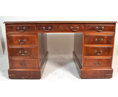 A Victorian style mahogany and leather twin pedestal Partners desk having tooled green leather inset to top, over twin pedest