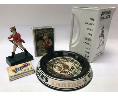 A small advertising figure of Johnnie Walker, Johnnie Walker water jug, ashtray and a pack of advertising playing cards