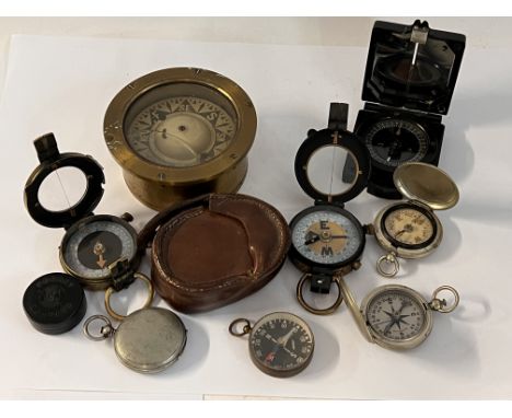 A collection of vintage compasses to include two Mother of Pearl dial compasses, US army Wittnaur compass, British military s