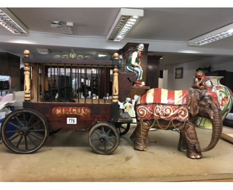 A Barnums circus model with seated clown and depicting elephant and monkey -pulling a cage with two bears. Length 75cm x 49cm