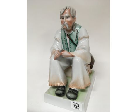 A large Hungarian ceramic Zsolnay hand painted figure of an seated man in traditional dress no obvious damage or restoration.