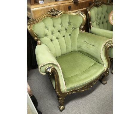An early 20th Century Italian style giltwood three piece suite in green button back upholstery.