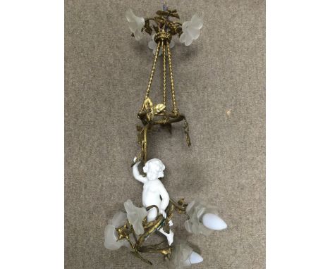 A French gilt metal and ceramic light fitting depicting a cherub within a foliate surround and a small gilt framed watercolou