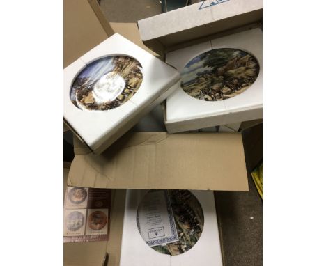 A collection of boxed collector's plates.