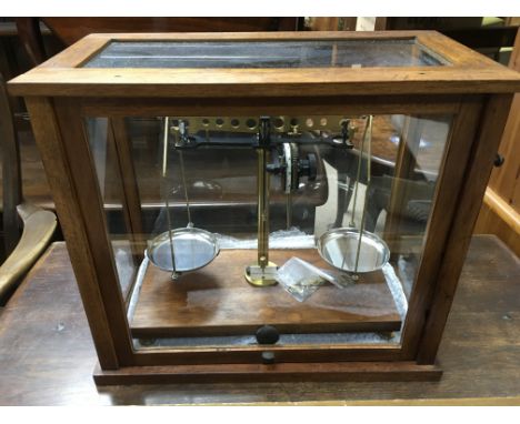 A cased set of beam balance scales.