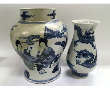 Two blue and white Oriental vases, the largest decorated with figures in a garden setting and measuring 31cm in height, the o