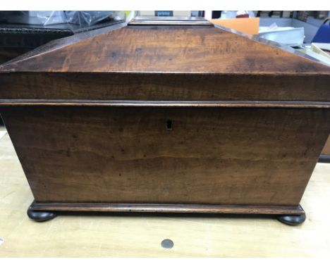 A Victorian mahogany tea caddy with inset glass liner .