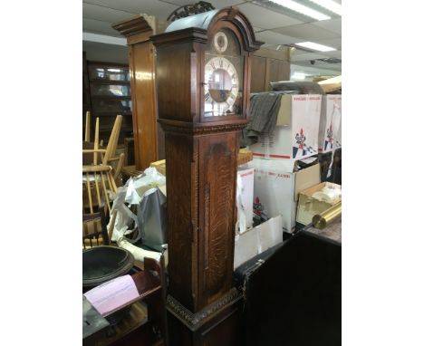 An oak longcase clock.