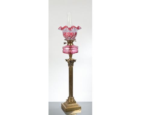 VICTORIAN BRASS OIL LAMP the white and cranberry glass shade above a cranberry glass oil reservoir and brass Corinthian colum