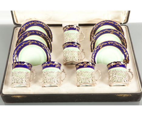 ROYAL DOULTON COFFEE SET the coffee cans in silver holders, maker JD&S, Sheffield marks, decorated in shades of green with bo