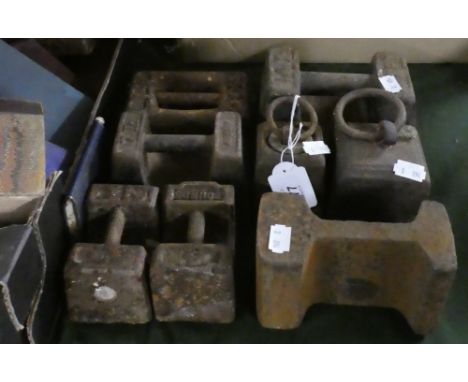 A Collection of Seven Cast Iron Scale Weights and a Section of Railway Track 