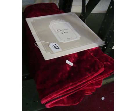 Three red velvet cushion covers and a Christian Dior scarf