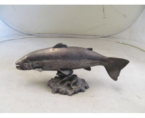 A silver clad model of a fish on naturalistic base 12" length