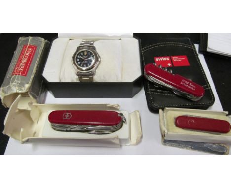 A Swiss Army watch, Notebook and calculator and three graduating penknives