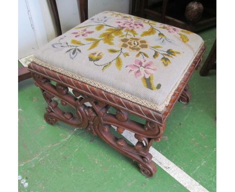 A tapestry top footstool on pierced scroll supports