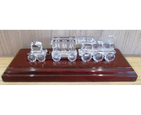 A Swarovski silver crystal train with carriage and tender on stand (slight chip and hook missing on engine retired 2003