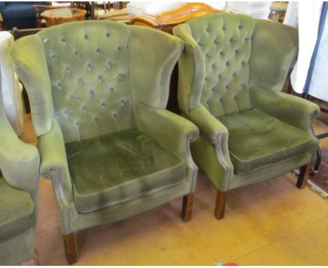 A pair of button wing armchairs on straight supports