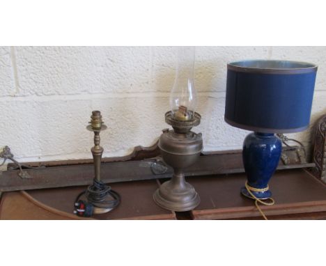 A brass oil lamp, two table lamps and a fine fender front