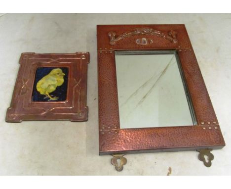 A small Arts and Crafts style copper framed mirror and an Arts &amp; Crafts style copper plaque with enamel chick to centre