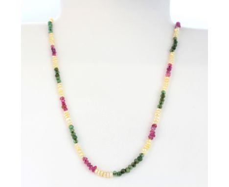 A ruby, emerald and seed pearl necklace with a yellow metal clasp, L. 46cm.