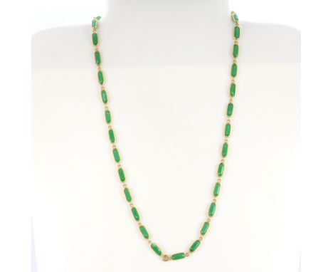 A yellow metal (tested high carat gold, approx. 22ct) jade set necklace, L. 52cm.