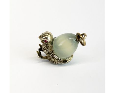 A white metal and jade egg and chick pendant with ruby eyes, H. 3.5cm. Tested silver and probably Russian.