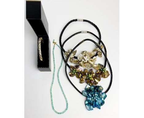 An aquamarine beaded necklace together with three mother of pearl necklaces and a gold plated stone set bangle.