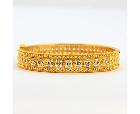 A heavy 22ct yellow and white gold bangle, inner dia. 5.5cm. Weight - 25.5g