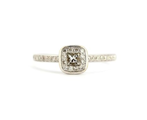 An 18ct white gold cluster ring set with a princess cut diamond surrounded by brilliant cut diamonds, (M.5).