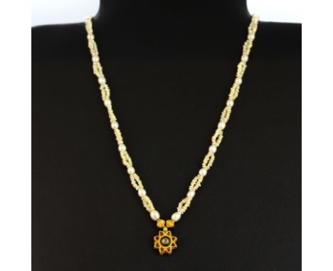 A freshwater pearl necklace with a yellow metal and cabochon ruby pendant  with a yellow metal (worn hallmark) clasp, L. 45cm