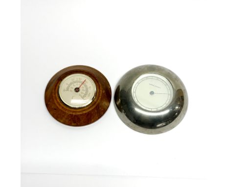 A Georg Jensen wall thermometer, Dia. 14cm together with a further thermometer.