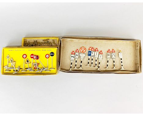 A set of Dinky Toys International road signs, a group of seated Army personnel and a Gilco traffic sign set.