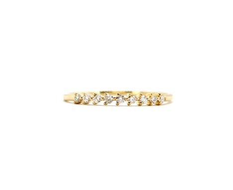 An 18ct yellow gold diamond set half eternity ring, (N).