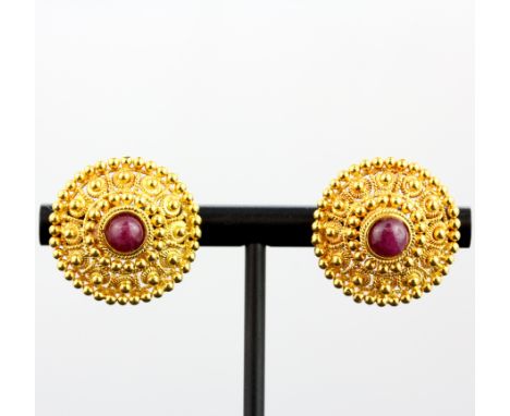 A heavy pair of 22ct yellow gold shield earrings each set with a round cabochon ruby, dia. 2cm. Weight - 4g