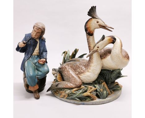 A Nao figure of a sailor, H. 27cm. Together with a large Lladro figures of two grebes, H. 34cm. Slightly A/F.