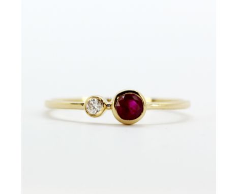 An 18ct yellow gold (stamped 750) diamond and ruby set ring,  (O.5).