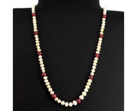 A freshwater pearl and ruby necklace with a white metal clasp, L. 49cm.