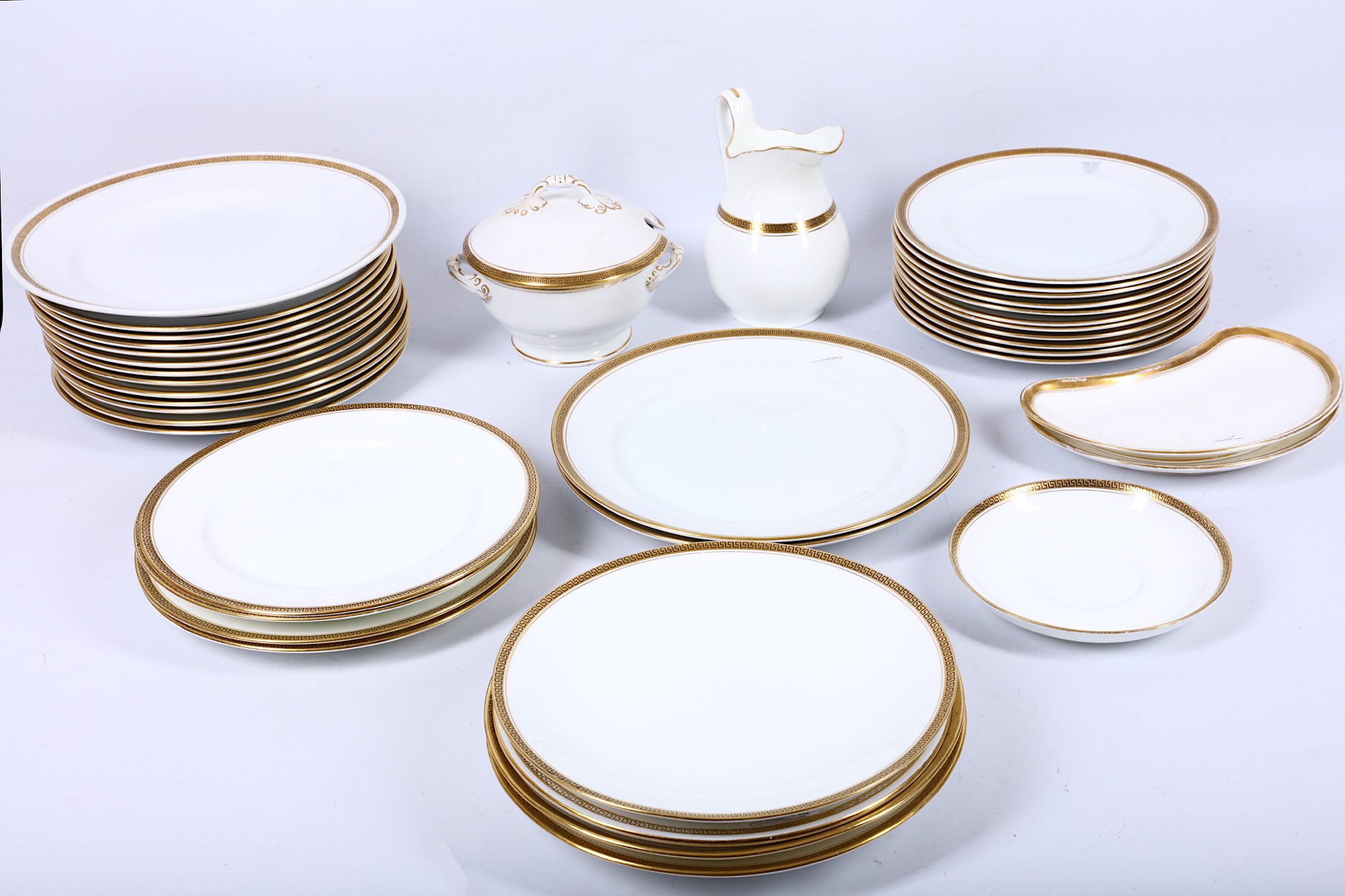 An extensive collection of bone china dinnerware in white with gold